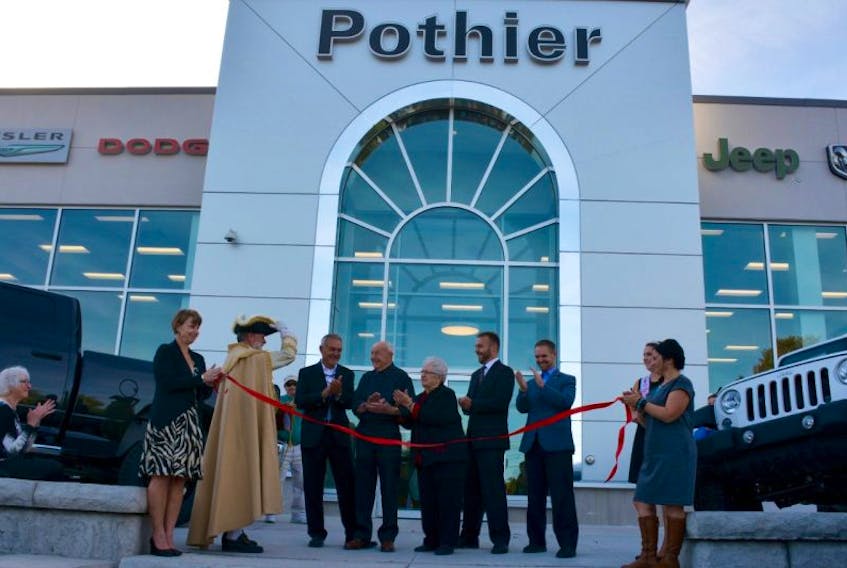 Three generations of the Pothier family gather to celebrate the grand re-opening of the Falmouth dealership. From left, Lynn Strong, Town Crier Lloyd Smith, John Pothier, Tom Pothier, Jackie Pothier, Chad Pothier, Jamie Pothier, Princess Windsor Savannah Sullivan, and Julie Taylor.