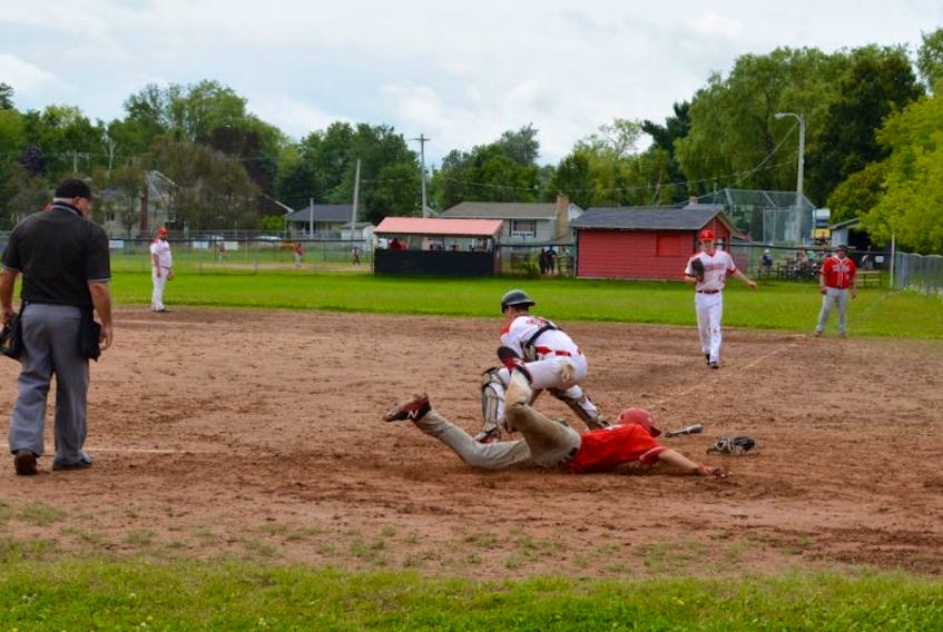 Windsor Knights player, Austin Sabean, dives for home plate during one of two winning games against the Truro Bearcats in Windsor on Aug. 13.