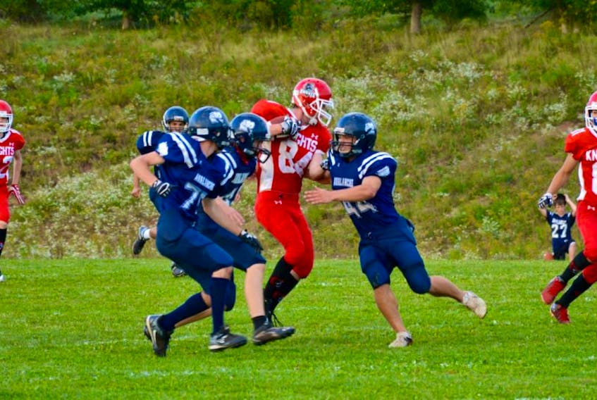 A Millwood Knights player gets surrounded by AV’s defence before being taken down.