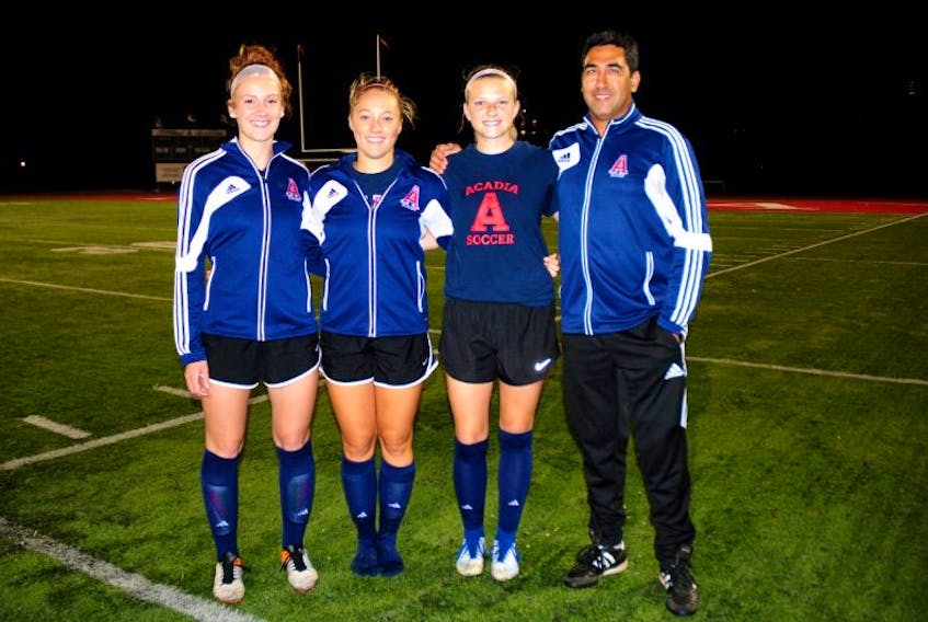 Acadia soccer players Rachel Cunningham, Gemma Leblanc and Jenna Howell are pictured with their coach, Amit Batra. These three varsity athletes have a unique connection on the field after playing together since elementary school.