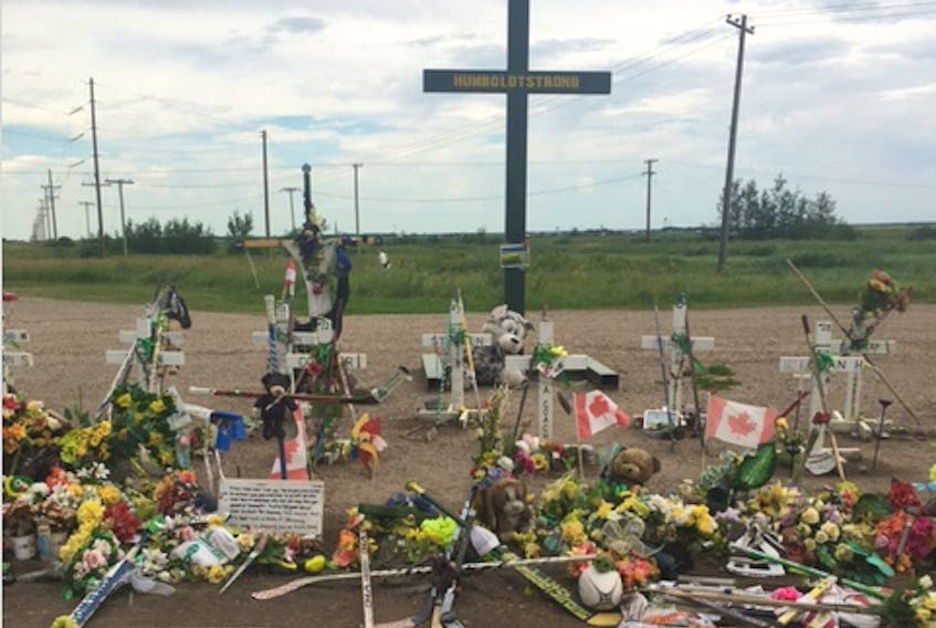 Hockey sticks, flowers and flags mark the ground around the crosses that remember the young men killed in the Humboldt bus crash last spring. Valley Wildcats owner Graham Baxter said his recent visit to the site “was quite emotional.”