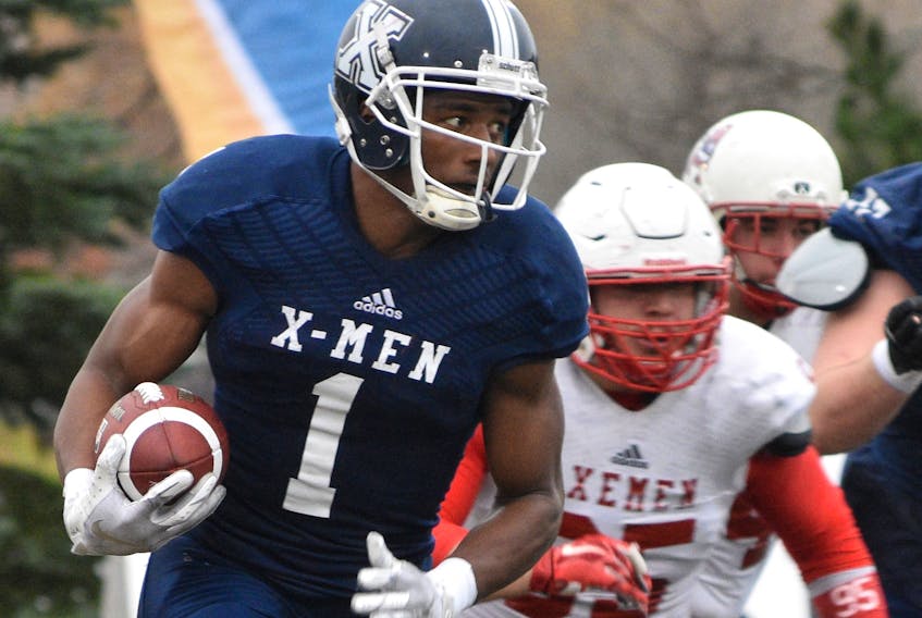 Kaion Julien-Grant of the St. F.X. X-Men gains yards after the catch in action versus the rival Acadia Axemen.