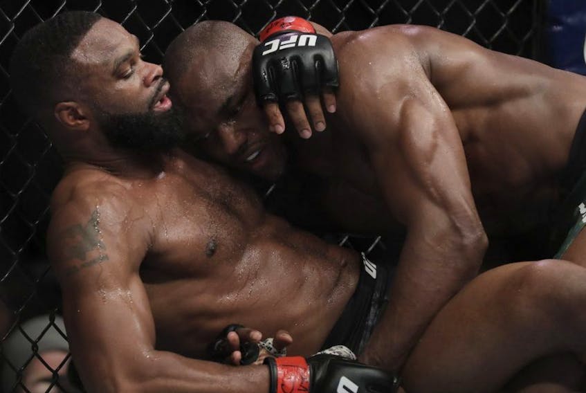Tyron Woodley (left) and Kamaru Usman (right) grapple during their welterweight title bout during UFC 235 at T-Mobile Arena in Las Vegas on March 2, 2019.