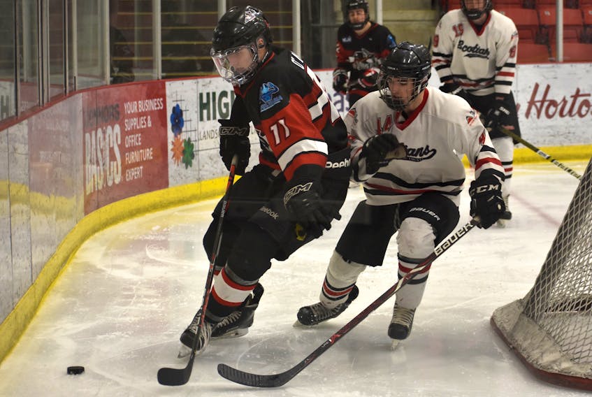 Chad O’Neill of the Kameron Jr. Miners, left, protects the puck from Jagger Statton of the Pictou County Scotians during Nova Scotia Junior Hockey League action last month at the Membertou Sport and Wellness Centre. Game 5 of the Miners’ series with the Strait Pirates will be played today at 7:30 p.m. in Membertou. JEREMY FRASER/CAPE BRETON POST