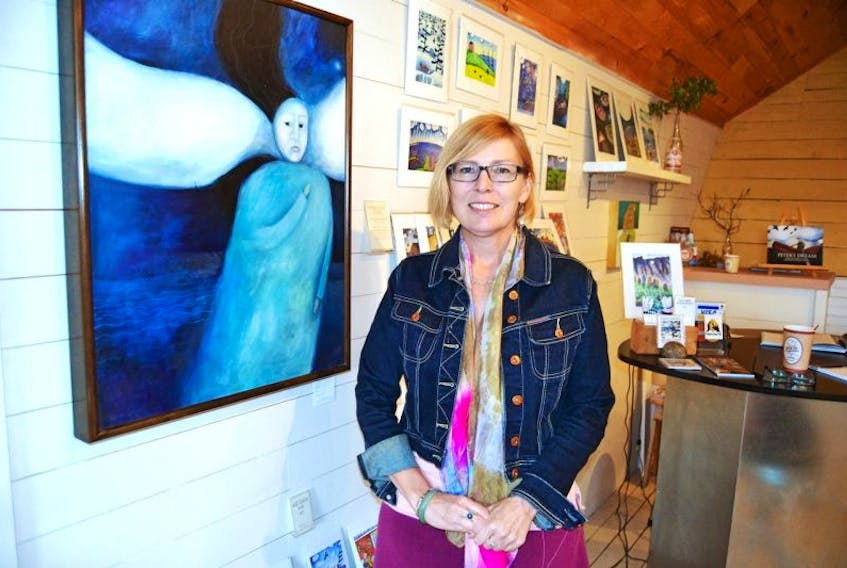Karen Gallant stands next to Blue Spirit at her studio gallery in Rustico. It's one of the illustrations in Peter’s Dream, a new book that matches the Island songs of Lennie Gallant with her paintings.<br /><br />