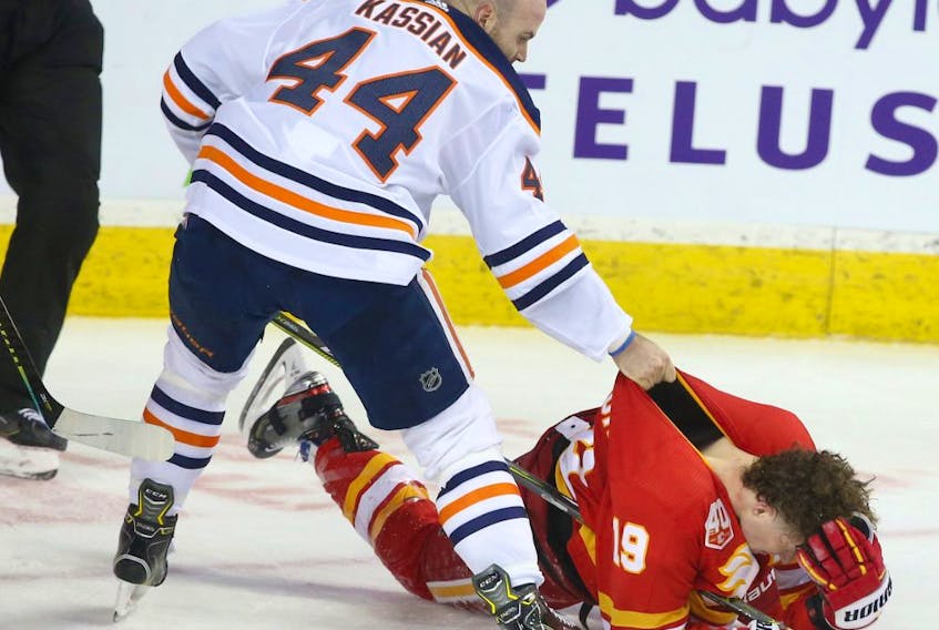 Oilers Zack Kassian and Flames Matthew Tkachuk battle in the second period during NHL action between the Edmonton Oilers and the Calgary Flames in Calgary on Saturday, January 11, 2020. 