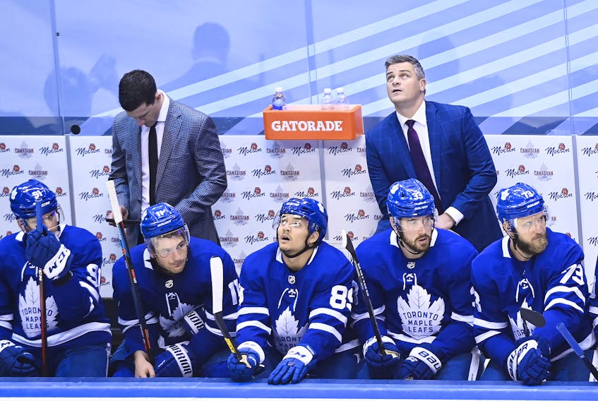 Maple Leafs head coach Sheldon Keefe (back right) looks at the scoreboard in the final seconds of of Game 1 against the Columbus Blue Jackets on Sunday. If it makes Keefe feel better, Pat Burns and Pat Quinn both lost their first playoff games behind the Maple Leafs bench. 
