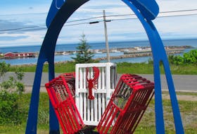 A three-trap display at the Royal Canadian Legion with Morien Bay as a backdrop. Bill Meadows has transformed lobster traps into planters, trellises, street address signs and patio trays, among other things. CONTRIBUTED