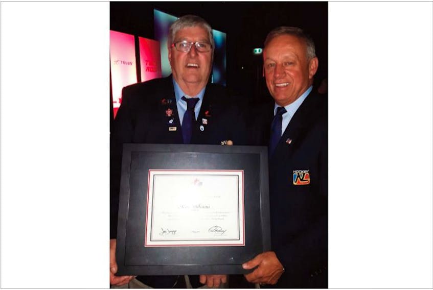 Kenny Williams (left) receives Hockey Canada Order of Merit from Hockey NL president Jack Lee.