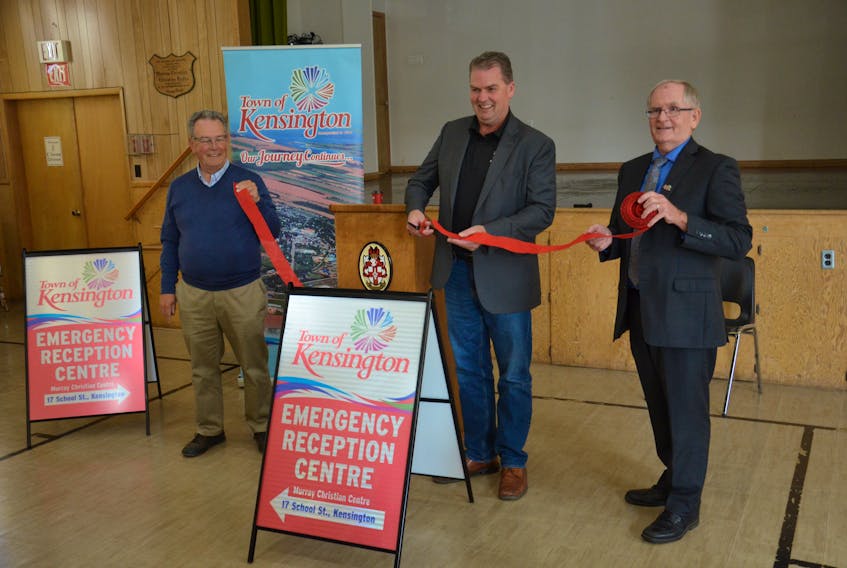 P.E.I. Public Safety Minister Bloyce Thompson, centre, cuts the ribbon to commission the Kensington Emergency Centre at the Murray Christian Centre on School Street on Saturday morning. Jim Blanchard, left, and Kensington Mayor Rowan Caseley hold the ribbon. Blanchard is the chairman of the official board of the Kensington United Church, which owns the building known as the Murray Christian Centre.