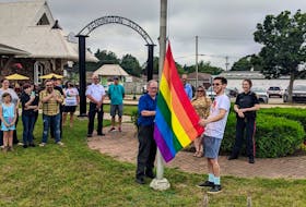 Kensington Mayor Rowan Caseley, left, and Pride P.E.I. member Tyler Murnaghan raise the Pride flag in the town square Wednesday. Pride events continue today and Saturday. 