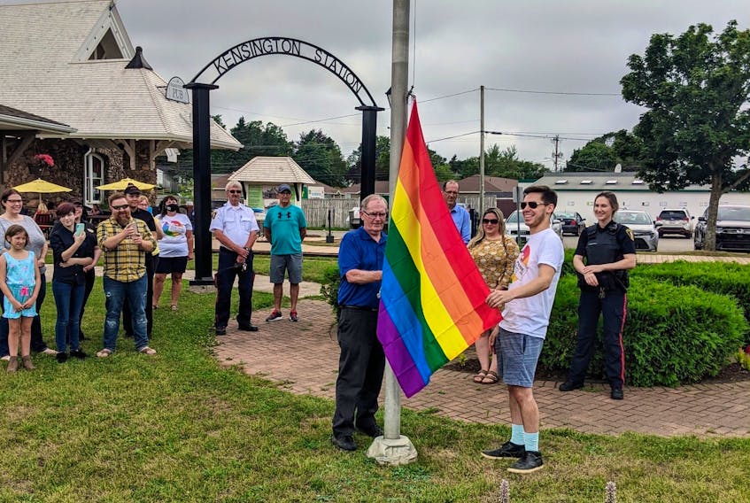 Kensington Mayor Rowan Caseley, left, and Pride P.E.I. member Tyler Murnaghan raise the Pride flag in the town square Wednesday. Pride events continue today and Saturday. 