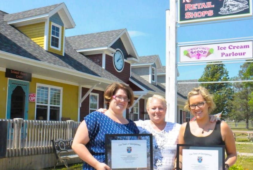 <span>The official opening of Kent Square was marked over the weekend during the Georgetown Summer Festival. Development board chairwoamn Kelly Gray, centre, congratulated some new vendors like Fern Gotell, left, and Desieree Bedryk.<br /></span>