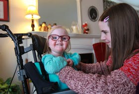 Charlotte Turner, 12, tickles her sister, Lyla, 4, in her grandparent's Halifax home. Lyla has CDKL5 deficiency disorder.
TIM KROCHAK/ The Chronicle Herald
 