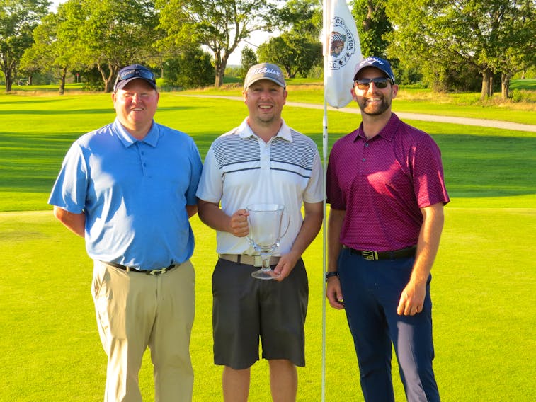 Kevin (Tuna) George, centre, birded the first playoff hole to claim the club championship at the Lingan Golf and Country Club in Sydney earlier this month. George edged out Clayton Floyd for the title. The two were tied after regulation with total scores of 142. With George are Jamie MacIntosh, Lingan head professional, left, and Skylar Erickson, Lingan assistant professional. CONTRIBUTED • LINGAN GOLF CLUB