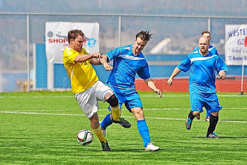 <p>Diane Crocker/The Western Star</p>
<p>West Side Monarchs’ Richard Wells, left, jostles with Jason Earle of Springdale for control of the ball during Molson Kick-Off Cup action Saturday at the Wellington Street Sports Complex. Springdale players Jarrett Newberry and Tim Pollett follow the play at right.</p>