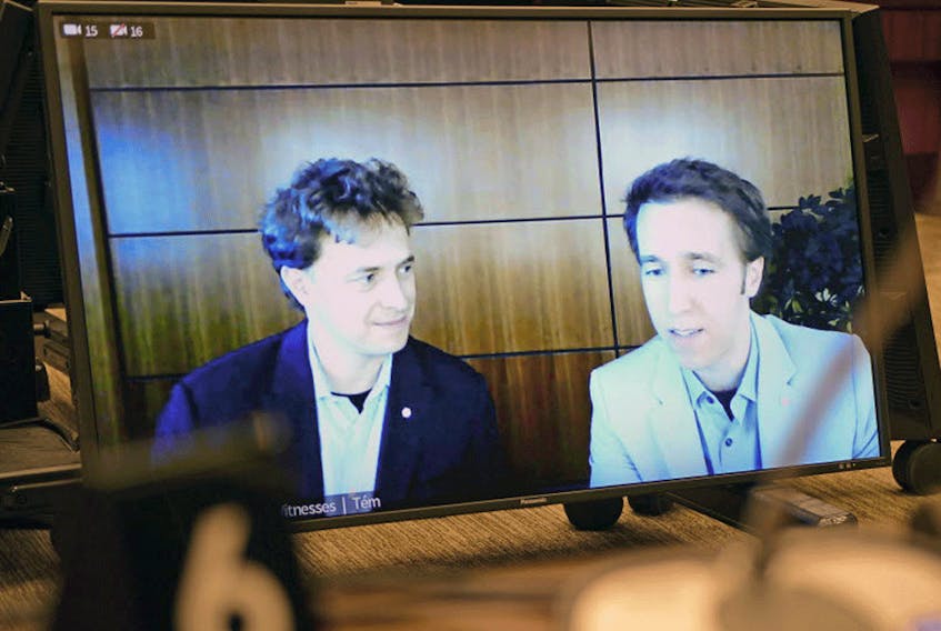 Marc, left, and Craig Kielburger appear as witnesses via videoconference during a House of Commons finance committee meeting in Ottawa on Tuesday.