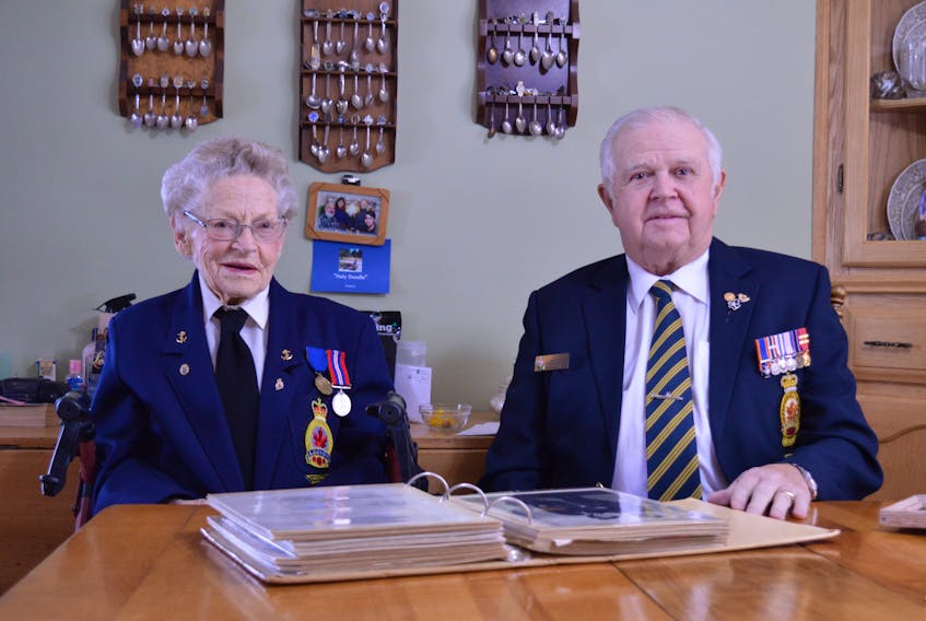 Jean MacLean and David Yeo look through MacLean's photos and memories of her time in the Women’s Royal Canadian Naval Service. 
