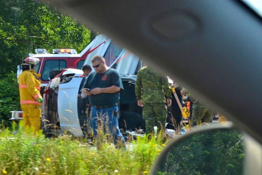 ['An accident on Highway 101 eastbound had traffic backed up at the Grand Pré exit as first responders worked to free people from a vehicle in a crash at the Avonport exit this afternoon, July 17. A vehicle with its rooff cut away can be seen in several of these photos.']