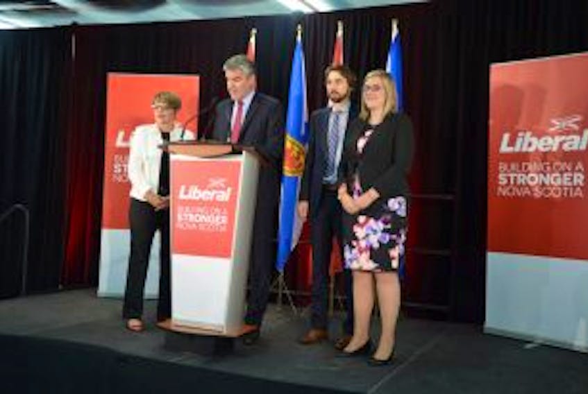 ['Flanked by his wife, Andrea, and children, Stephen McNeil addresses party faithful that gathered at the Bridgetown Curling Club around 12:30 a.m. on May 31.']