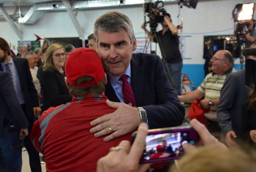 Stephen McNeil gets a hug from a supporter as he arrives at the Bridgetown Curling Club.