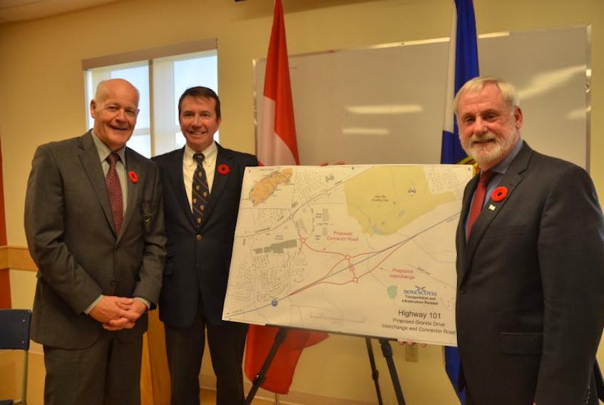 Kings County Mayor Peter Muttart, Kings-Hants MP and Treasury Board president Scott Brison and Kings South MLA Keith Irving with a rendering of the Highway 101 Granite Drive interchange project.