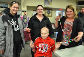 Karissa Bezanson, sitting, has some help holding out the long string of nearly 200 bravery beads that represent every medical procedure she’s undergone at the IWK Health Centre in Halifax since November. Pictured with Karissa is Jennifer Oake, Rachel Hudgins and her mother, Shannon Hohmann.
