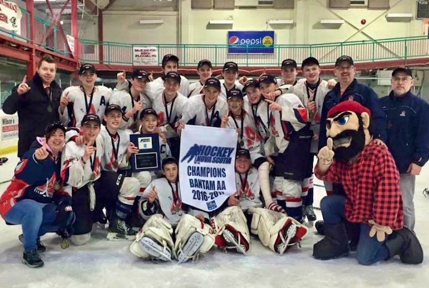 The Acadia Axemen Bantam AA team poses for a photo with their provincial championship banner after beating Glace Bay 7-1 in the finals.