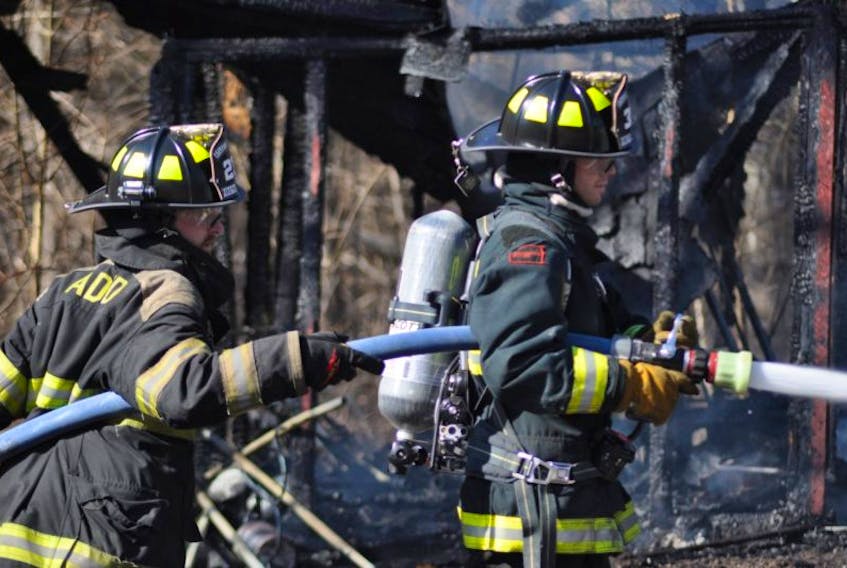 Firefighters from Aylesford work to extinguish hotspots at the scene of a blaze that broke out in a garage in Factorydale April 15.