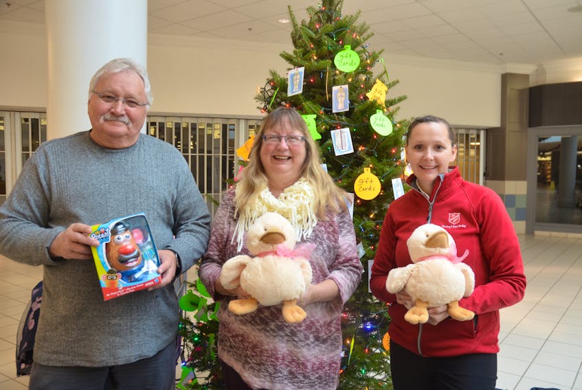 Mike and Lynda Carter of Canning and Capt. Kelly Fifield of the Kentville Salvation Army with toy donations at the Angel Tree in the County Fair Mall in New Minas.