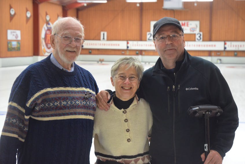 Wolfville Curling Club member and Curl for Cancer participant Charlie Wood, event co-chairwoman Marilyn Campbell Profitt and event chairman Dean Smith recognize that many members of the club have had their lives touched by cancer.