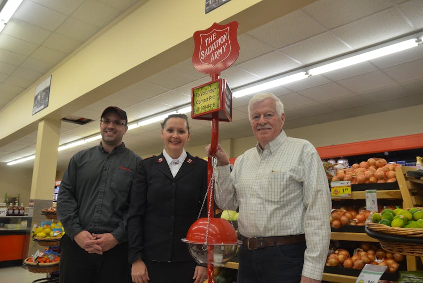 Kentville Foodland co-owner Aaron Cossaboom, Capt. Kelly Fifield of the Kentville Salvation Army and new Christmas kettle campaign co-ordinator Phil Warren with a kettle set up at the Kentville Foodland. Donations of money and time are needed to make the campaign a success.