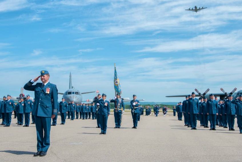 Newly-appointed 14 Wing Greenwood Commander Colonel Mike Adamson leads the July 20 change of command parade through the advance in review order, as one of the wing’s signature CP140 Aurora flies overhead.