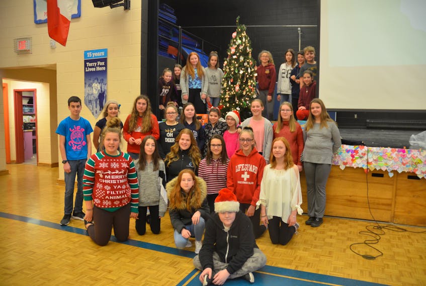 Evangeline Middle School students gather around the Tree of Hope just prior to a special assembly on Dec. 21 where money raised and gifts donated through the initiative were presented to representatives of Chrysalis House and the Kids Action Program.