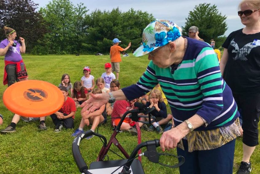 Helen Hiltz watches to see if the Frisbee she tossed will land in a nearby hula hoop set out as her target. Hiltz had an audience comprised of Grand View Manor residents and Berwick and District School students when she accomplished this field day feat.