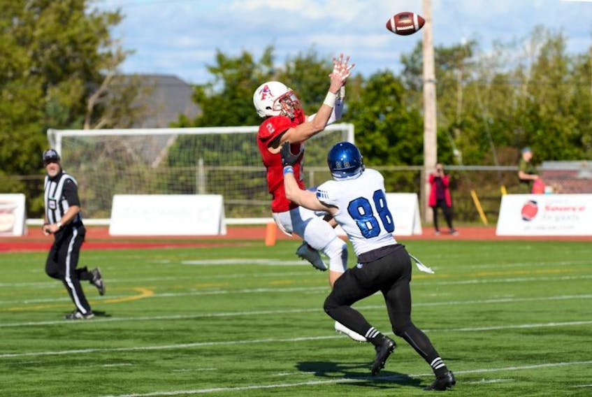 Acadia football player Brandon Jennings jumps for an incoming pass.