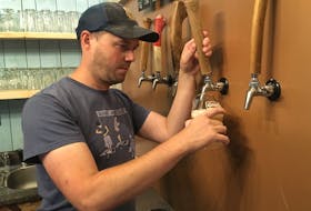 Sean Ebert serves up a glass of Lunn’s Mill beer. The brewmaster followed his passion and ended up opening a craft brewery with three business partners in Lawrencetown.