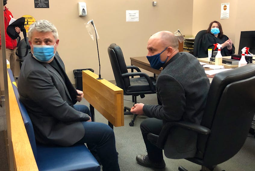 Kurt Churchill (left) sits in provincial court in St. John's with his lawyer, Robby Ash, Friday. Churchill was recently found guilty of threatening a police officer and is asking the court for a discharge.