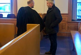 Kurt Churchill (right) shakes the hand of his lawyer, Robby Ash, before leaving Newfoundland and Labrador Supreme Court in St. John's Monday afternoon.