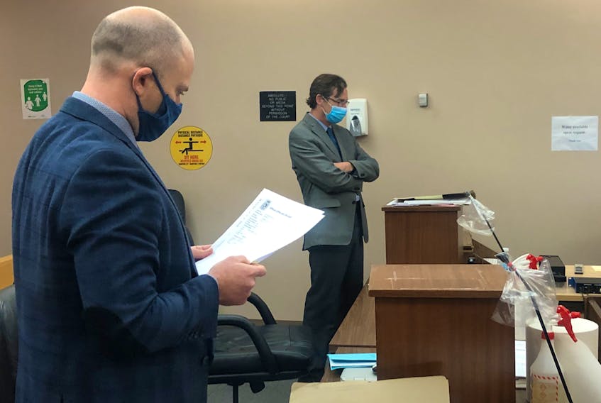 Kurt Churchill's lawyer, Robby Ash (foreground), and prosecutor Mike Murray proceeded with Churchill's trial Monday, even though Churchill was not present in the courtroom. The 43-year-old was convicted of threatening a police officer in March 2019.