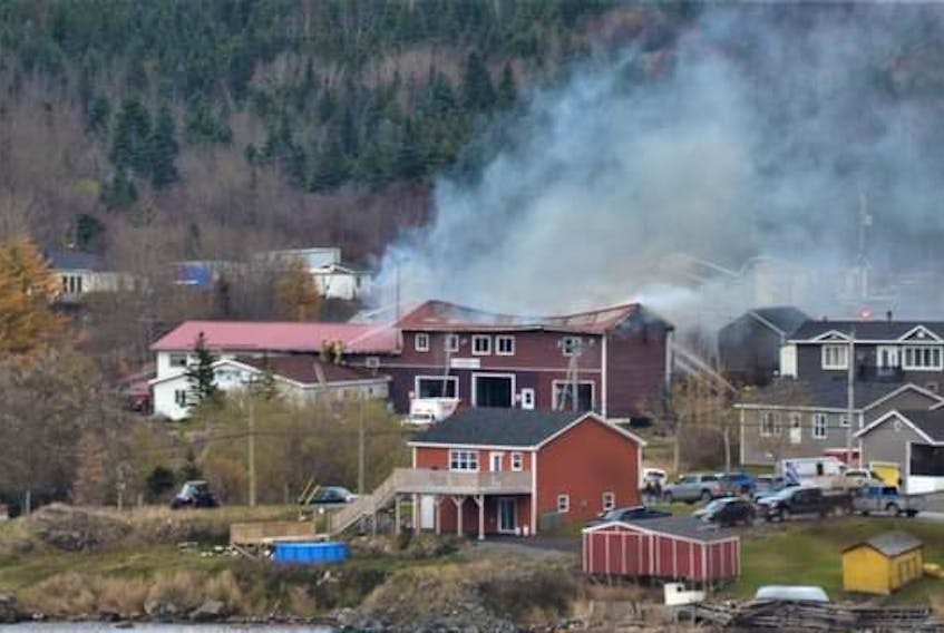 The smoke from the fire at the La Scie municipal centre rises above the town on Saturday. The municipal building also housed the town’s fire department, ambulance service, council chambers, family resource centre and library. Contributed photo. 