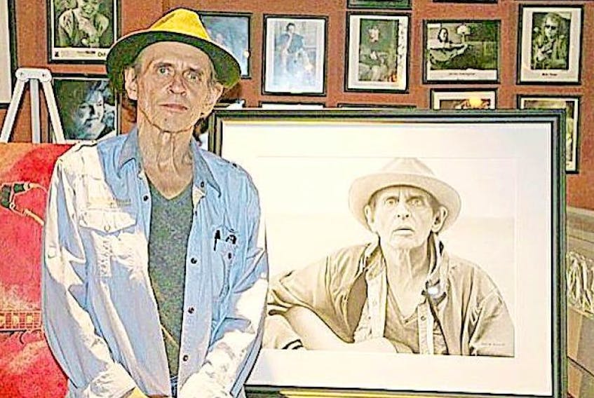 Ron Hynes poses with the artwork from his CD “Later That Same Life,” a charcoal portrait of him by artist Roger Schmidt, at Toronto’s Hugh’s Room. The CD was released quietly Dec. 30, six weeks after Hynes’ death.