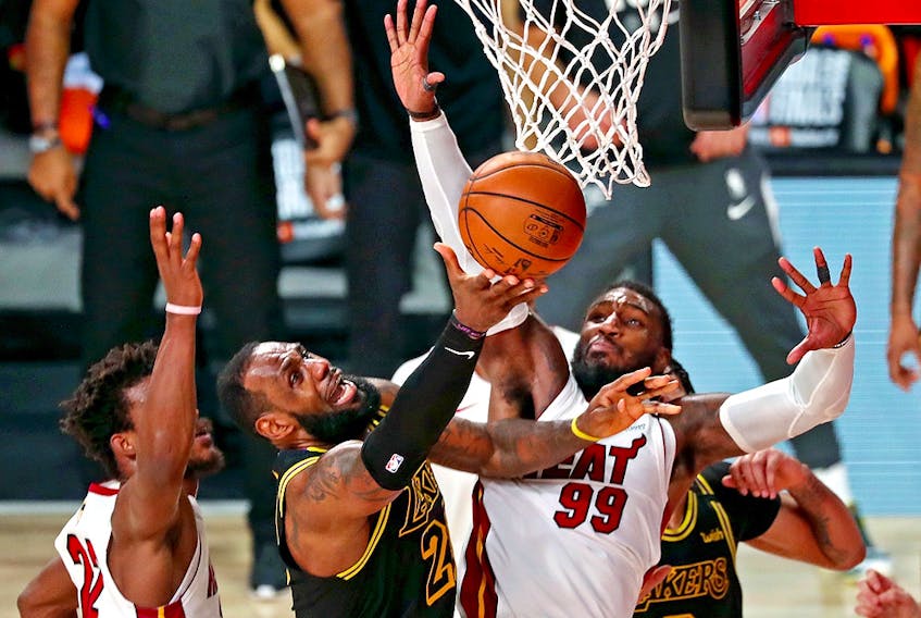 Los Angeles Lakers forward LeBron James (23) shoots the ball against Miami Heat forward Jae Crowder (99) and forward Jimmy Butler (22) during Game 5 of the 2020 NBA Finals at AdventHealth Arena. 