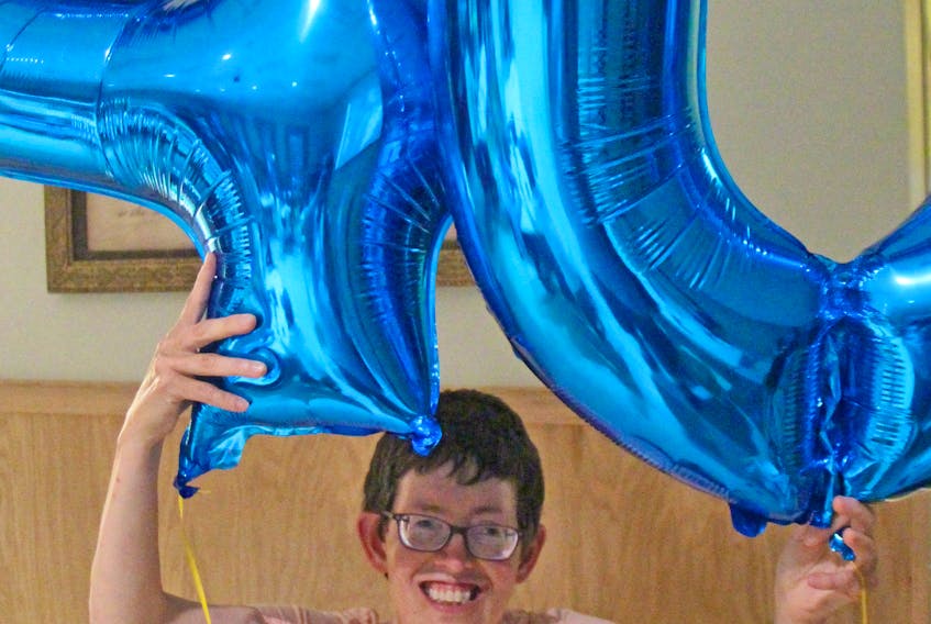 L’Arche Antigonish member Kelly Farrell shows off the colourful balloons that were on display during a meet-and-greet gathering Aug. 9 at St. James United Church Hall, as part of a recent 40th anniversary celebration weekend. Corey LeBlanc