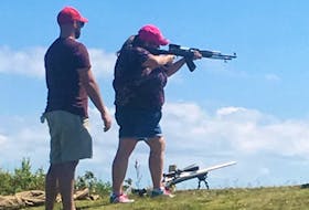 Heather Ford shoots an AR-15 at a Women Shooters of P.E.I. workshop under the watchful eye of a member of the P.E.I. Rifle Association.The workshop was held at the range at Alexandra Point.