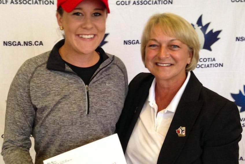 Laura Reid, left, accepts the top prize from NSGA president Shirley D’Entremont after she and her playing partner Peggy Kenny, not pictured, teamed up to win the NSGA women’s two-ball championship July 28 at Berwick Heights. 