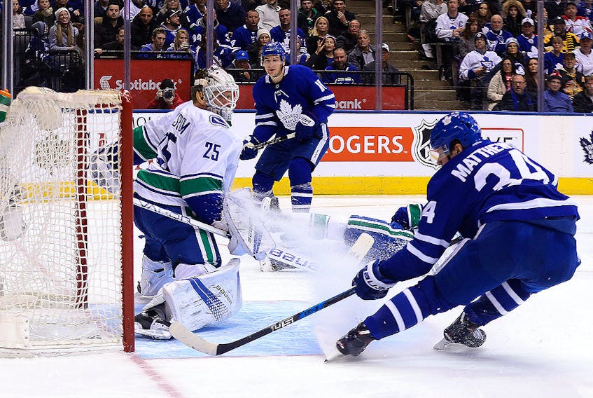 In this Jan. 7, 2018, file photo, Auston Matthews of the Toronto Maple Leafs scores on Jacob Markstrom of the Vancouver Canucks during NHL action at the Air Canada Centre in Toronto.