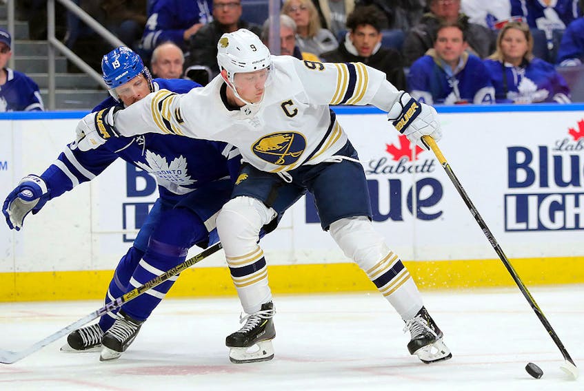 Buffalo Sabres centre Jack Eichel (9) holds off Toronto Maple Leafs centre Jason Spezza (19) with the puck at KeyBank Center. (Timothy T. Ludwig-USA TODAY Sports)