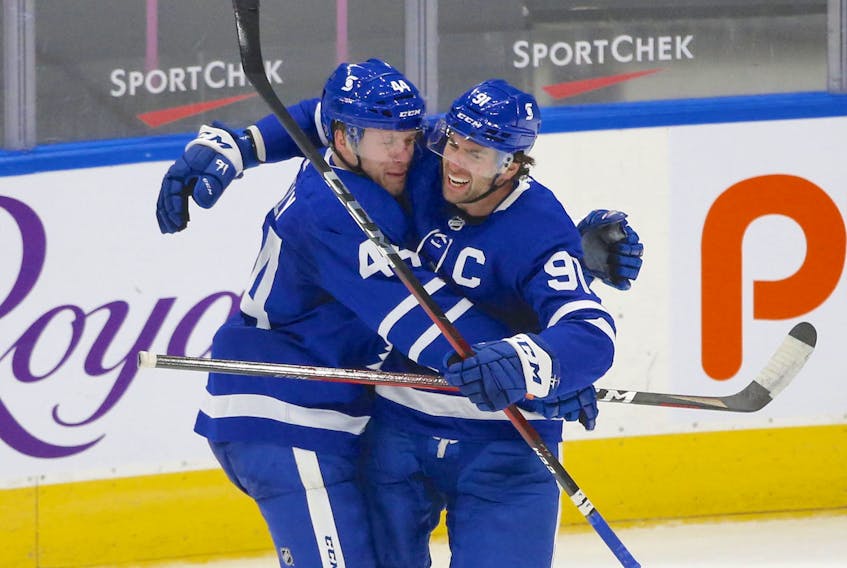 Maple Leafs defenceman Morgan Rielly (44) celebrates his overtime goal with John Tavares, who set up the game-winner, on Wednesday at an empty Scotiabank Arena. 