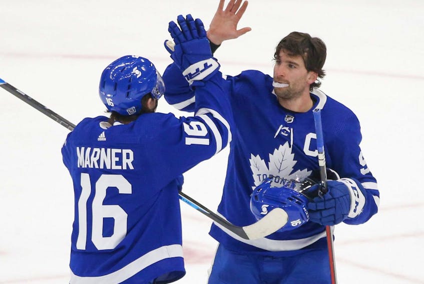 Toronto Maple Leafs John Tavares C (91) congratulates teammate Mitch Marner after their 4-2 win over the Oilers in Toronto on Friday January 22, 2021.